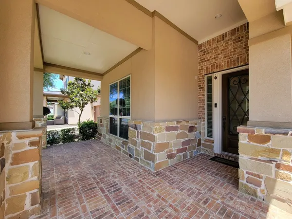a view of a porch with furniture and yard