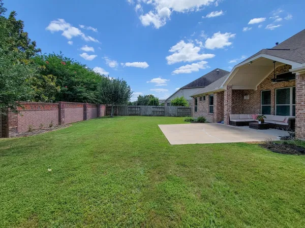 a view of a house with a yard table and chairs