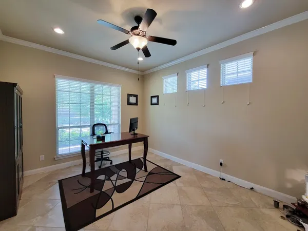 a view of a workspace with furniture and a window