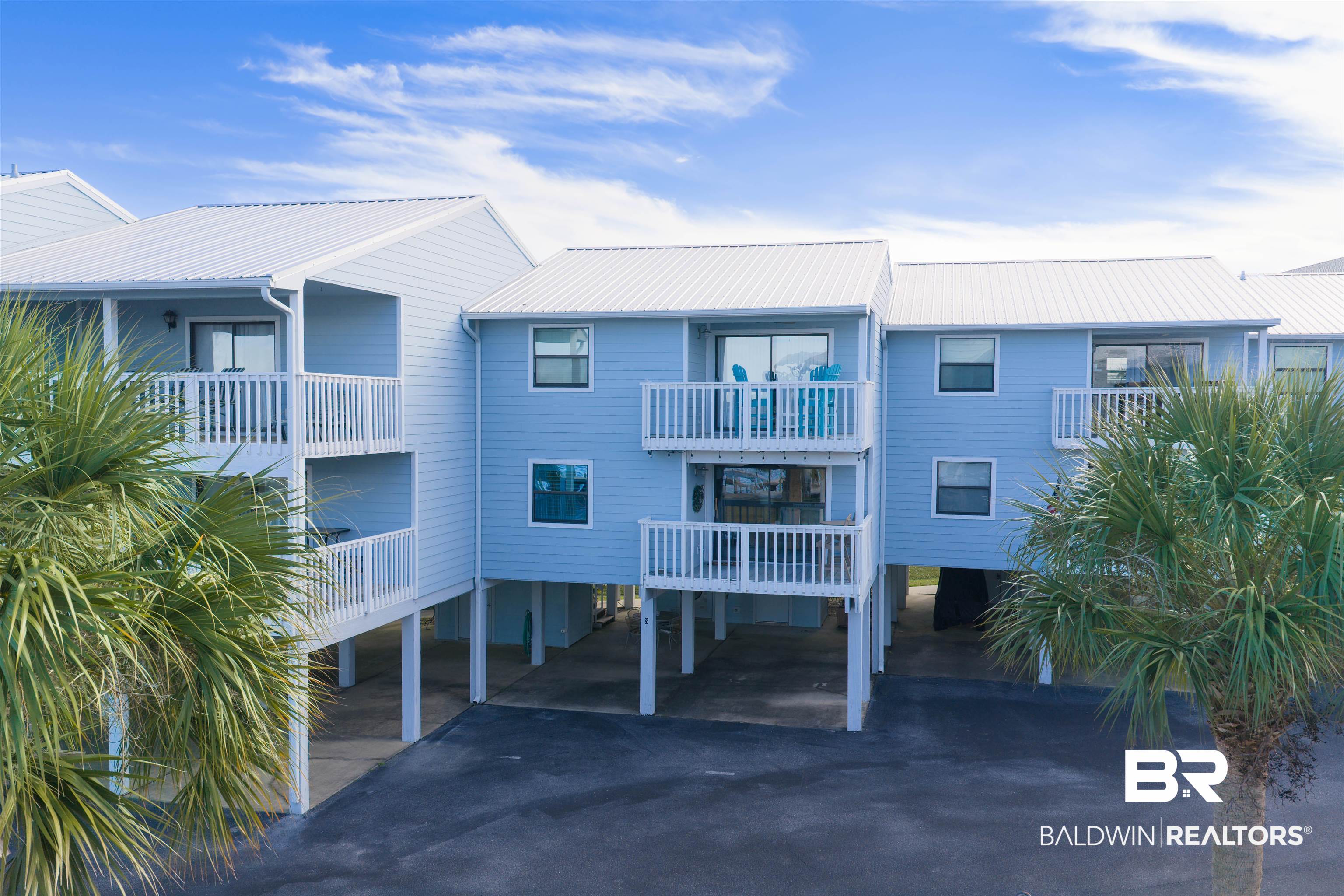 25861 Canal Road, Unit 3 Orange Beach, AL 36561 - Photo 1 of 40 View of front facade featuring a carport, a balcony, and driveway
