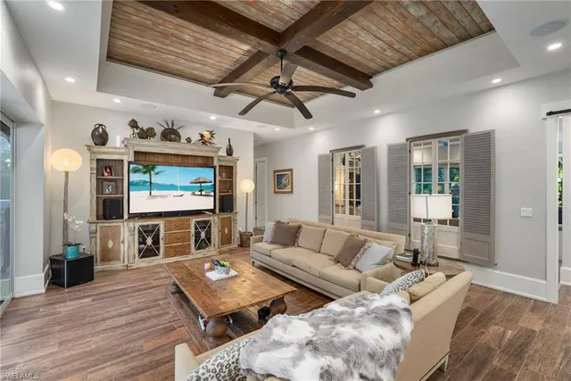 a living room with lots of furniture and a chandelier