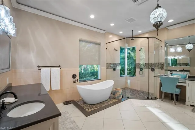 a bathroom with a granite countertop sink a toilet and shower