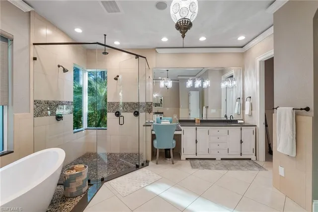 a bathroom with a granite countertop sink mirror vanity bathtub and a toilet
