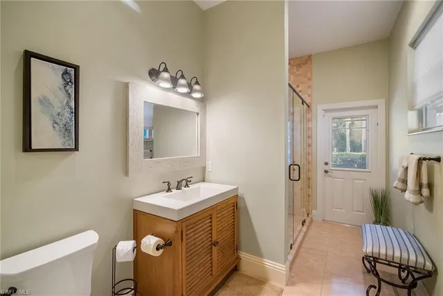 a dining room with wooden floor and a floor to ceiling window