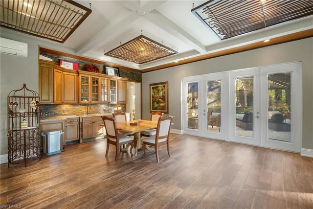 a room with stainless steel appliances granite countertop lots of counter space and furniture