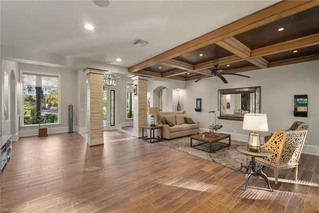a living room with lots of furniture and wooden floor