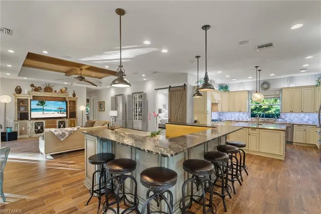 a large kitchen with a table and chairs