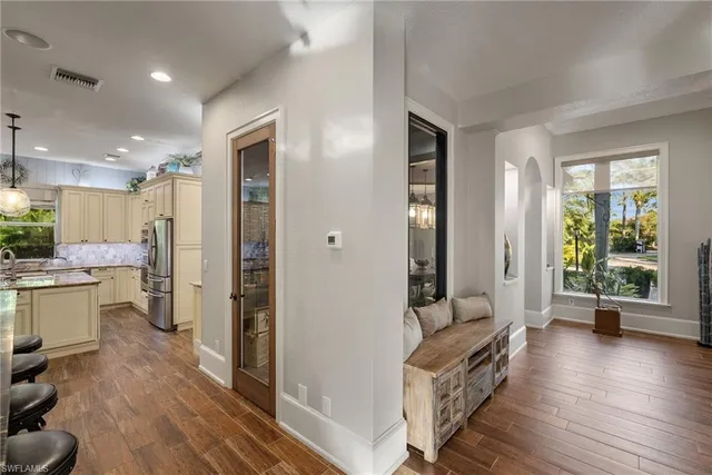 a room with a bed and wooden floor