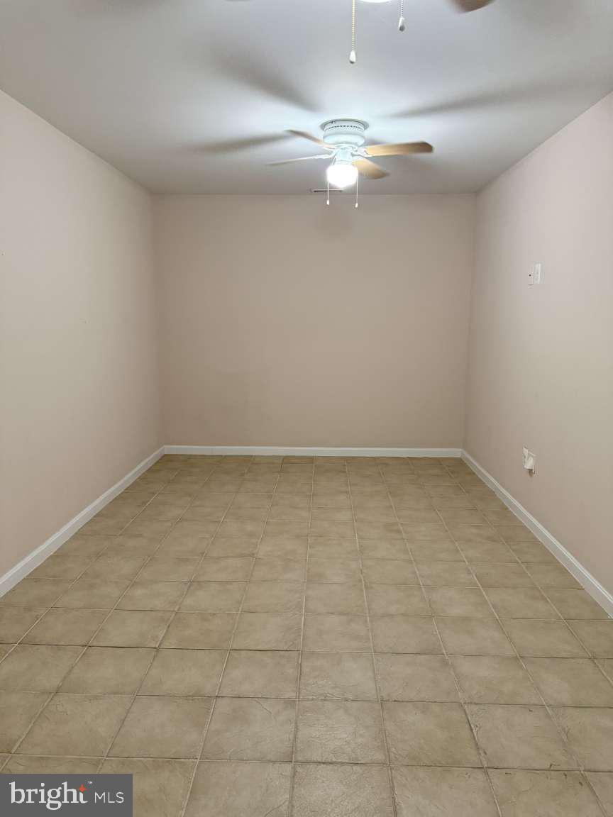 629 Ruxton Road, Unit 74 Solomons, MD 20629 - Photo 16 of 24 en empty room with white walls and tiles