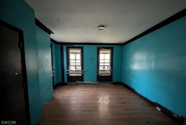 an empty room with windows and closet