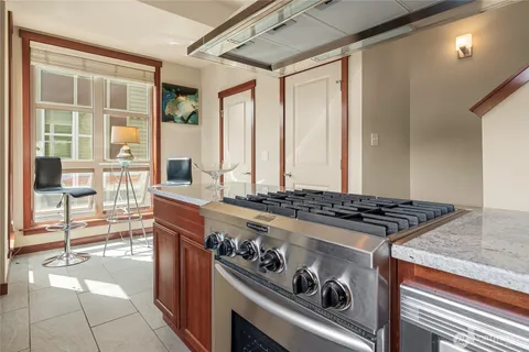 a kitchen with stove and cabinets