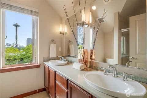 a bathroom with a double vanity sink and a mirror
