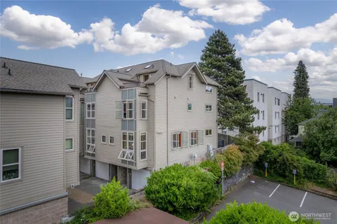 a view of a large building with a big yard and large tree