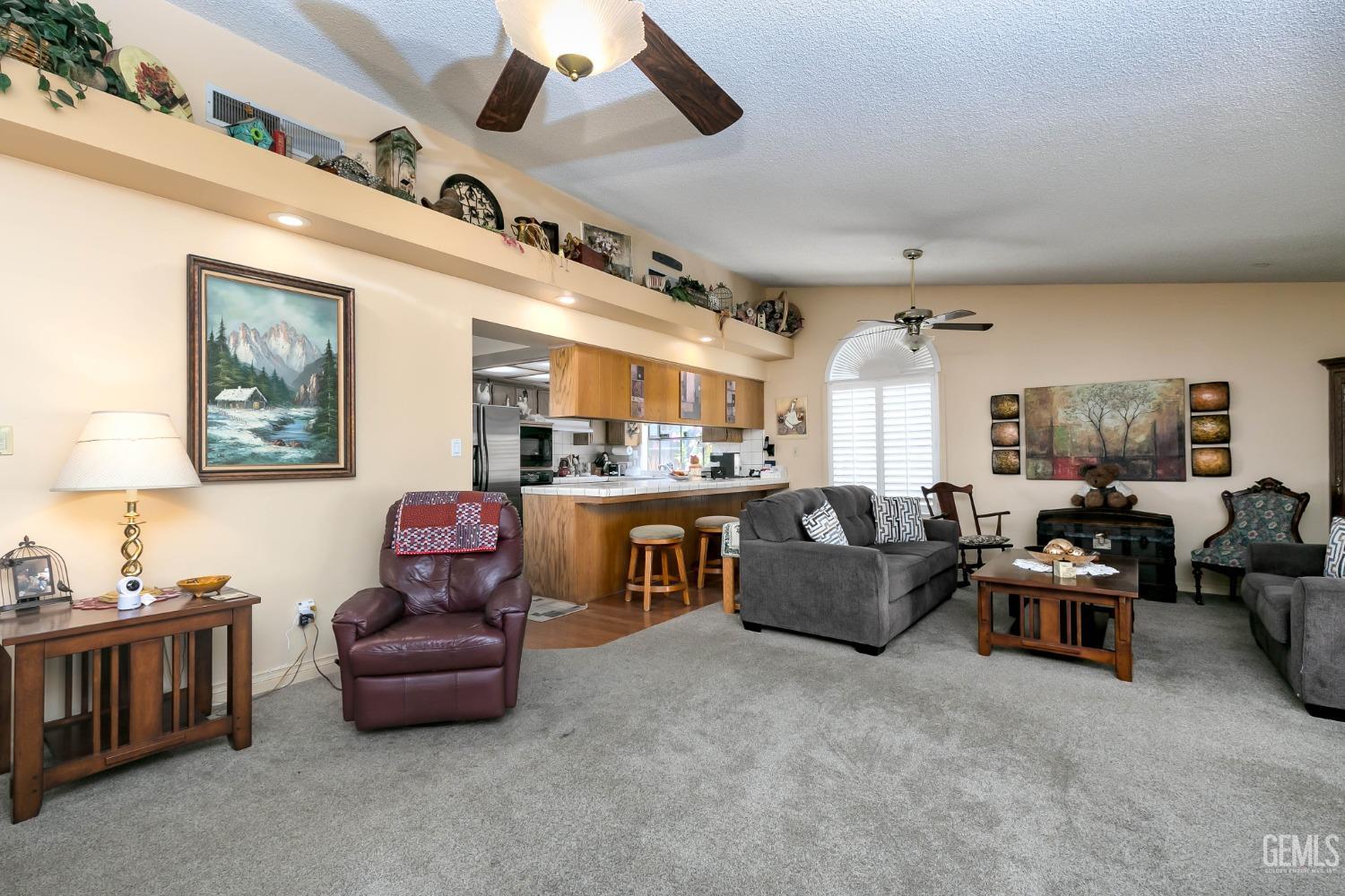 Undisclosed Address Bakersfield, CA 93312 - Photo 12 of 27 a living room with furniture and a kitchen
