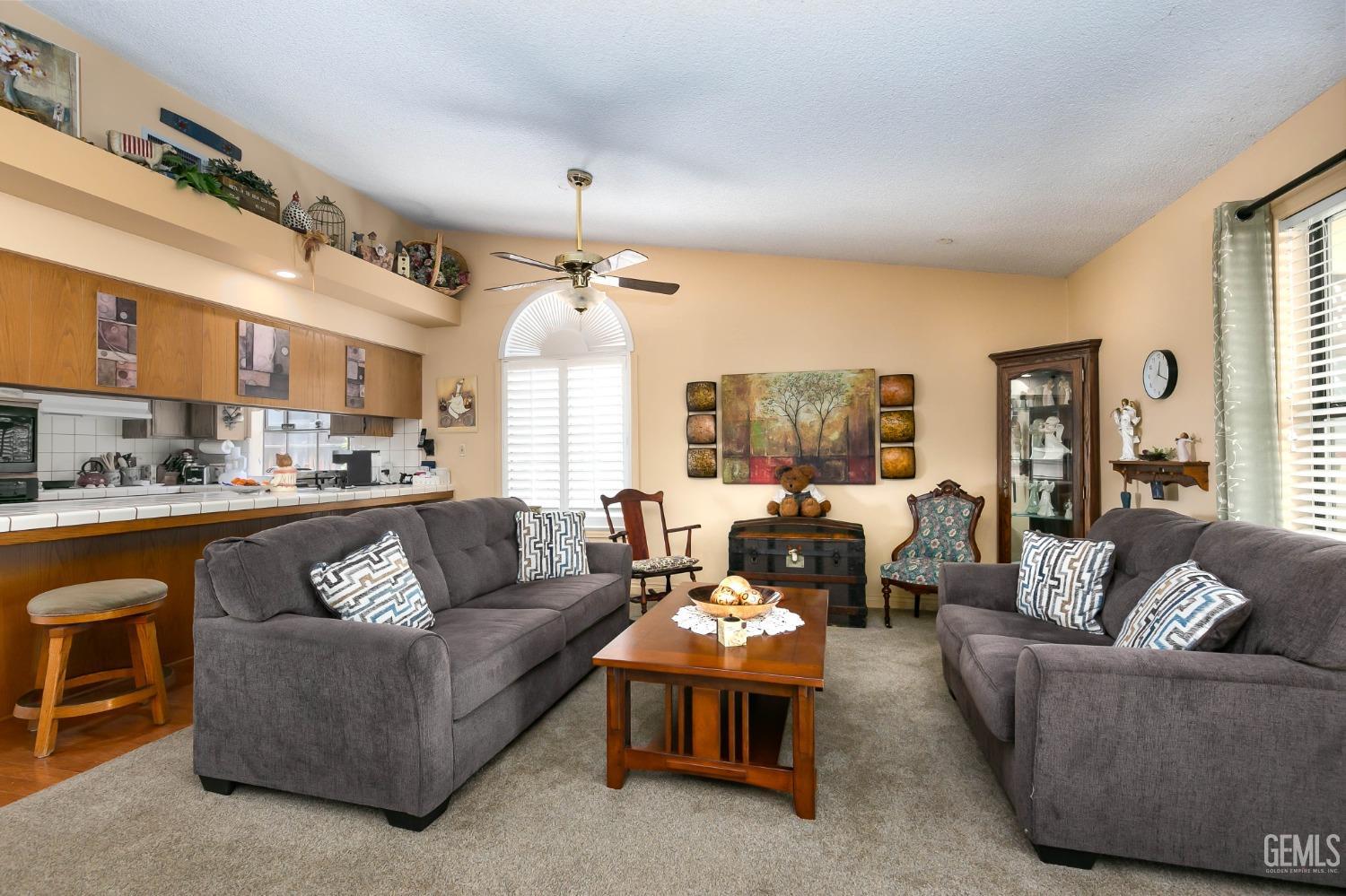 Undisclosed Address Bakersfield, CA 93312 - Photo 13 of 27 a living room with furniture kitchen and a chandelier