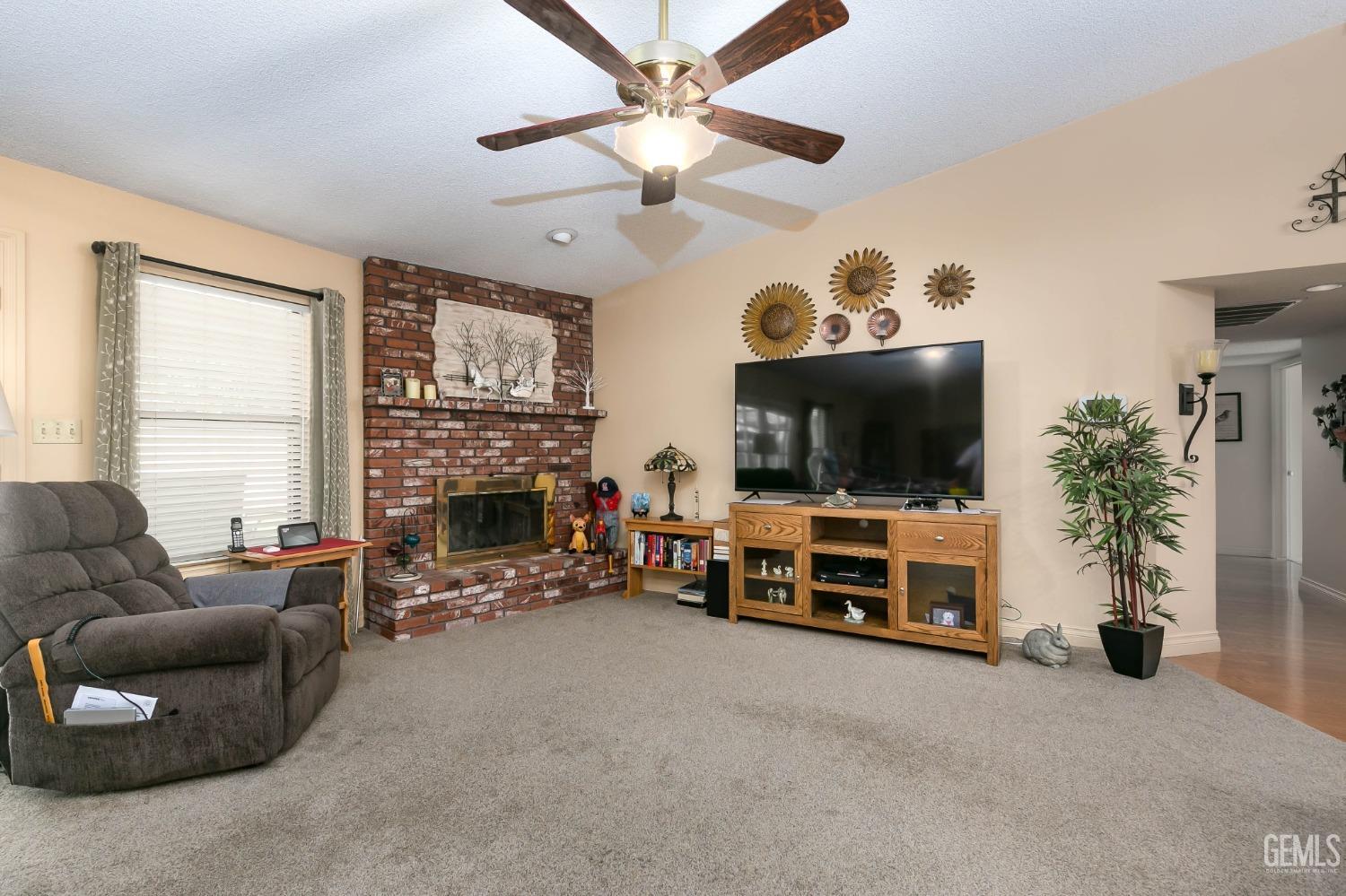 Undisclosed Address Bakersfield, CA 93312 - Photo 14 of 27 a living room with furniture and a flat screen tv