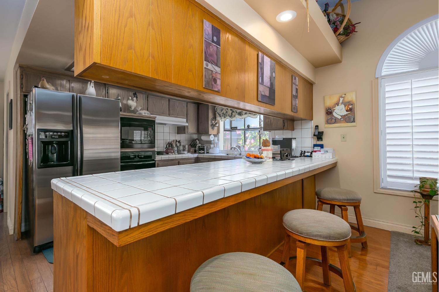 Undisclosed Address Bakersfield, CA 93312 - Photo 15 of 27 a kitchen with stainless steel appliances granite countertop a sink a stove and a refrigerator