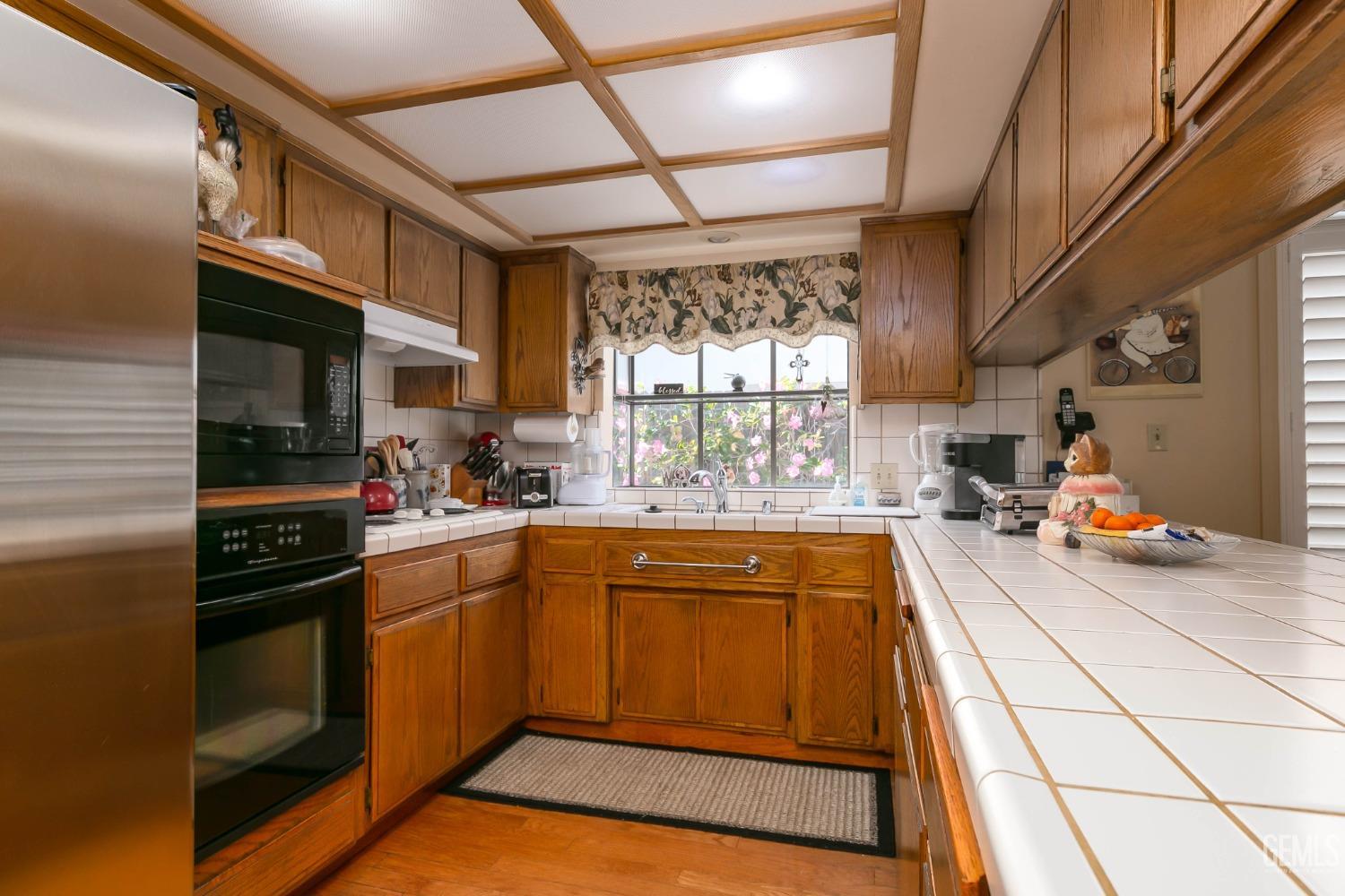 Undisclosed Address Bakersfield, CA 93312 - Photo 16 of 27 a kitchen with a sink appliances cabinets and a large window