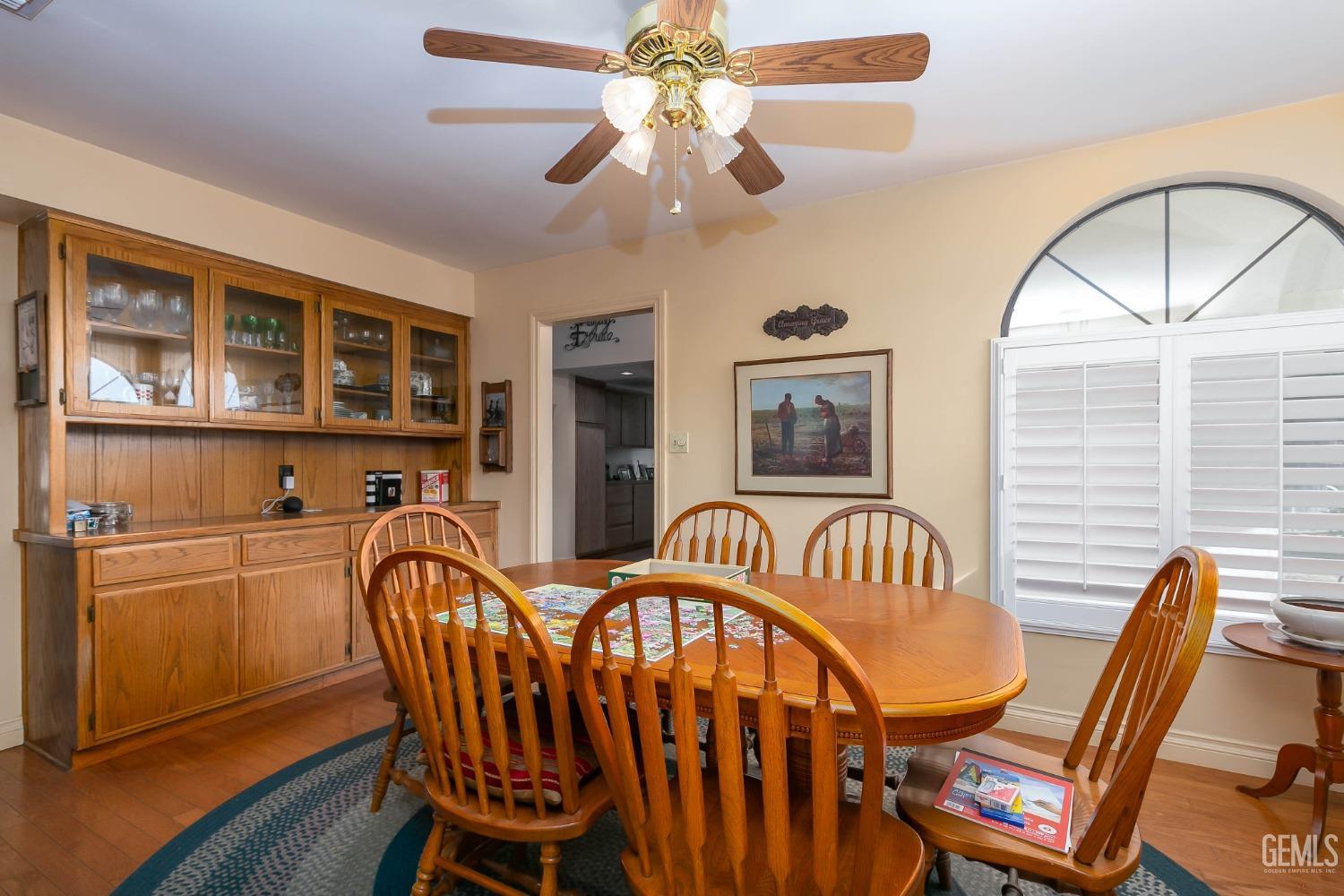 Undisclosed Address Bakersfield, CA 93312 - Photo 19 of 27 a dining room with furniture a chandelier and wooden floor
