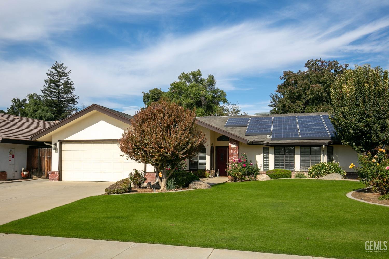 Undisclosed Address Bakersfield, CA 93312 - Photo 2 of 27 a front view of a house with a yard