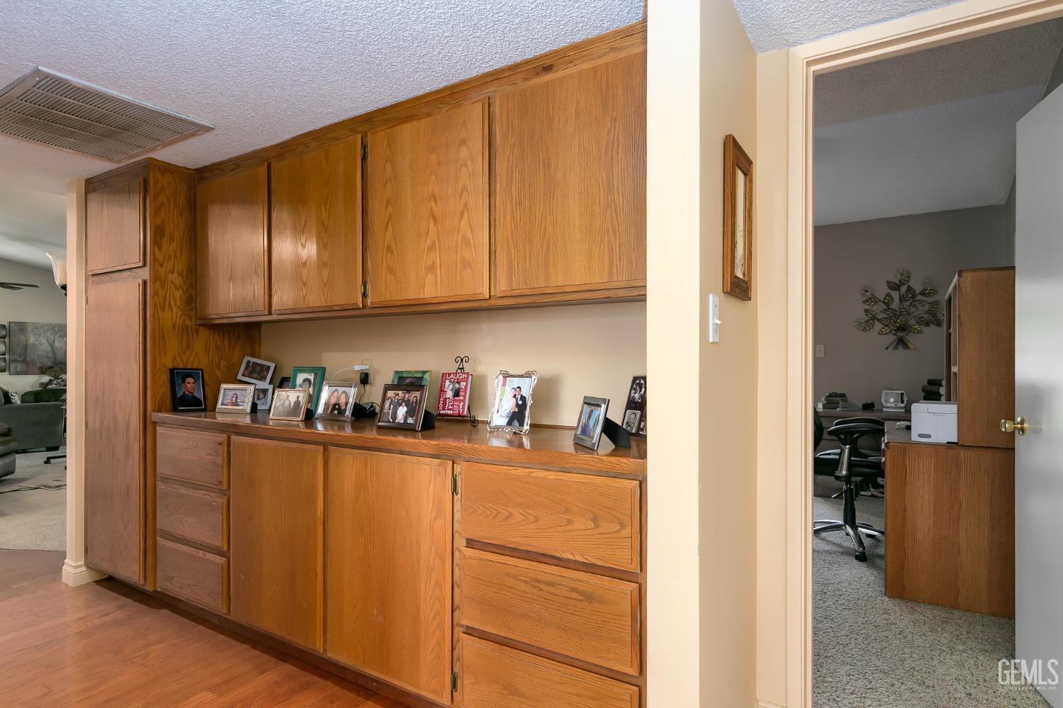 Undisclosed Address Bakersfield, CA 93312 - Photo 21 of 27 a kitchen with cabinets and a refrigerator