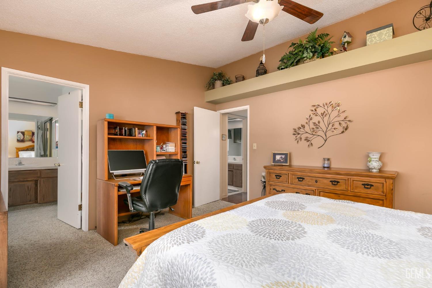 Undisclosed Address Bakersfield, CA 93312 - Photo 23 of 27 a bedroom with a bed and a chandelier