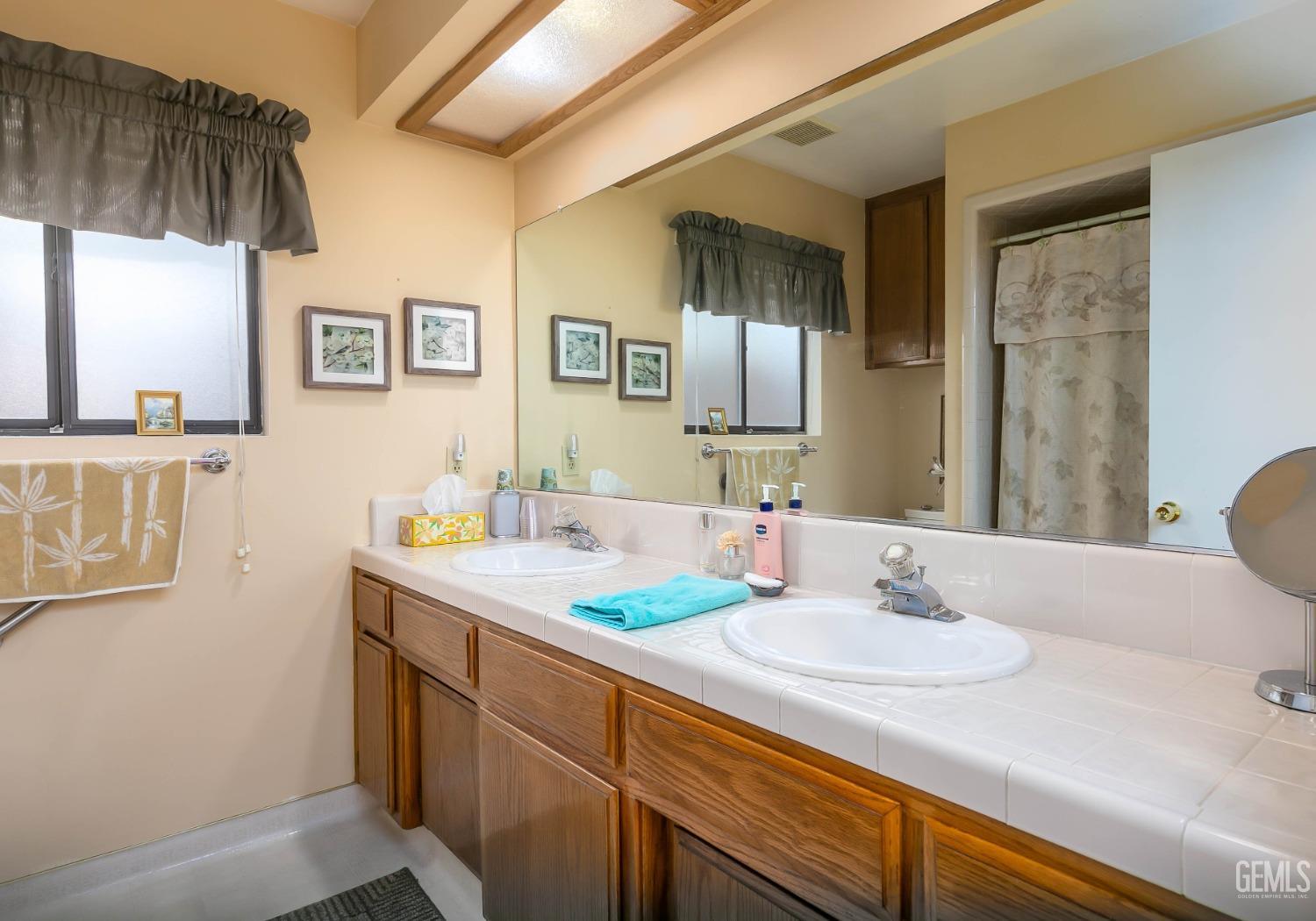 Undisclosed Address Bakersfield, CA 93312 - Photo 27 of 27 a bathroom with a sink double vanity and a mirror