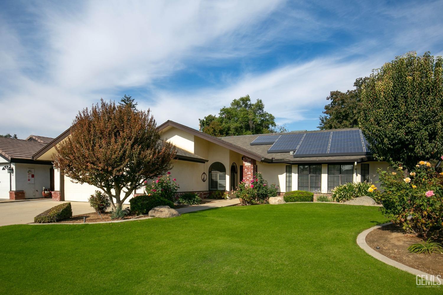 Undisclosed Address Bakersfield, CA 93312 - Photo 3 of 27 a front view of a house with a garden