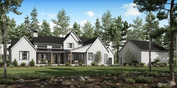 a front view of a house with a garden and trees