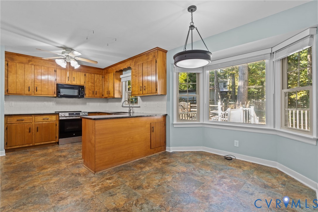 4717 Cedar Cliff Road Chester, VA 23831 - Photo 13 of 46 a kitchen with stainless steel appliances granite countertop a stove and a sink