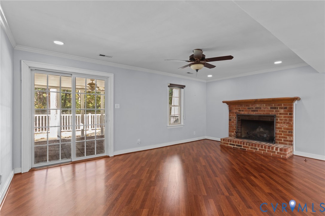 4717 Cedar Cliff Road Chester, VA 23831 - Photo 4 of 46 a view of an empty room with wooden floor and a window