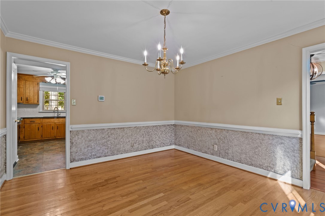 4717 Cedar Cliff Road Chester, VA 23831 - Photo 8 of 46 a view of a room with wooden floor and chandelier