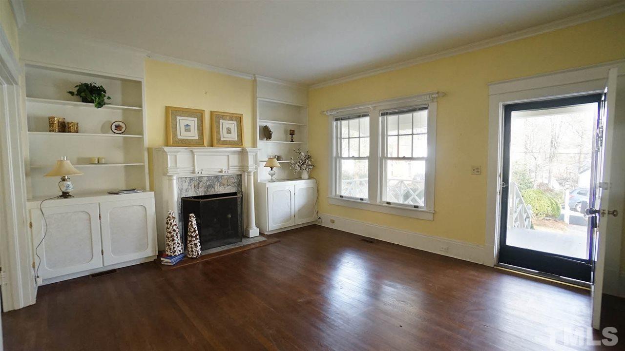 2251 The Circle Raleigh, NC 27608 - Photo 2 of 29 Living Room Features Fireplace with Architectural Details and surrounded by Bookshelves and Built-in Cabinetry