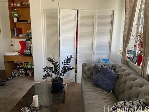 a living room with furniture and flowers