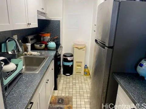 a kitchen with a sink a stove and refrigerator