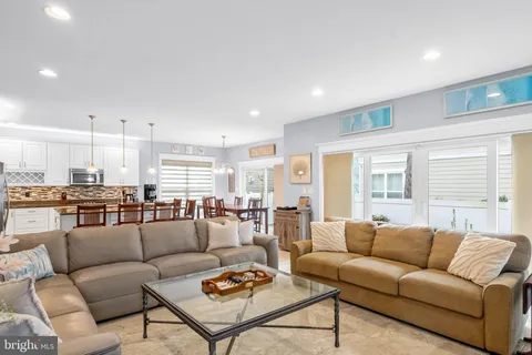 a living room with furniture kitchen view and a table