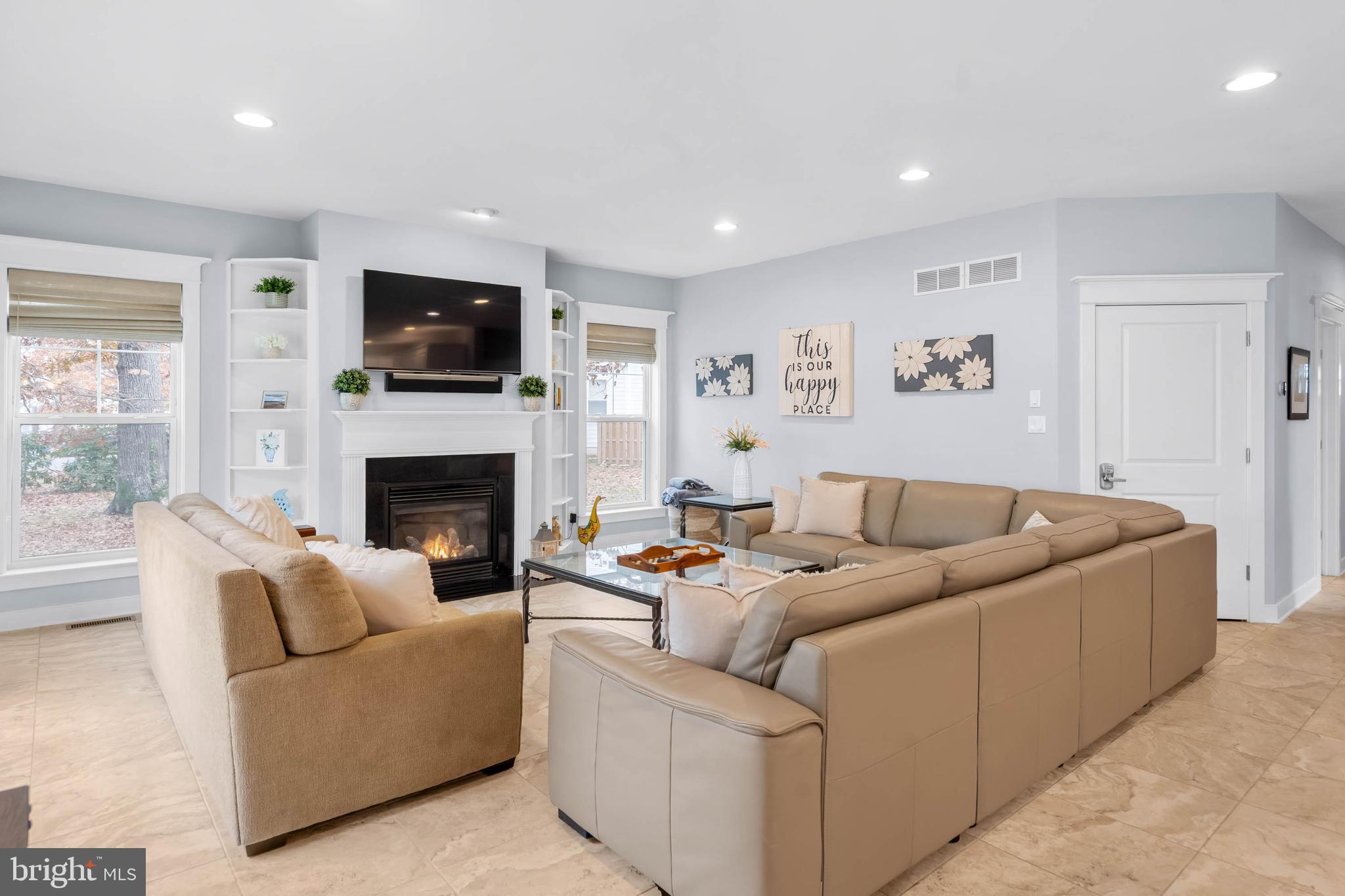 507 Jones Lane Rehoboth Beach, DE 19971 - Photo 15 of 62 a living room with furniture a flat screen tv and a fireplace