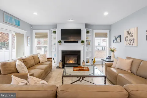 a living room with furniture fireplace and a flat screen tv
