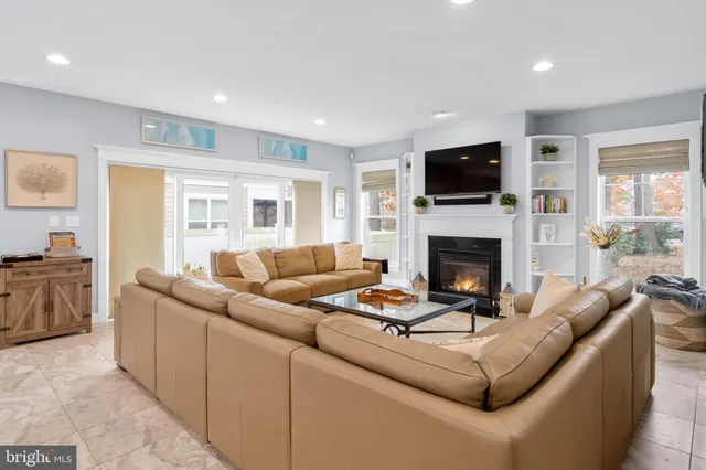 a living room with furniture a dining table and a wooden floor