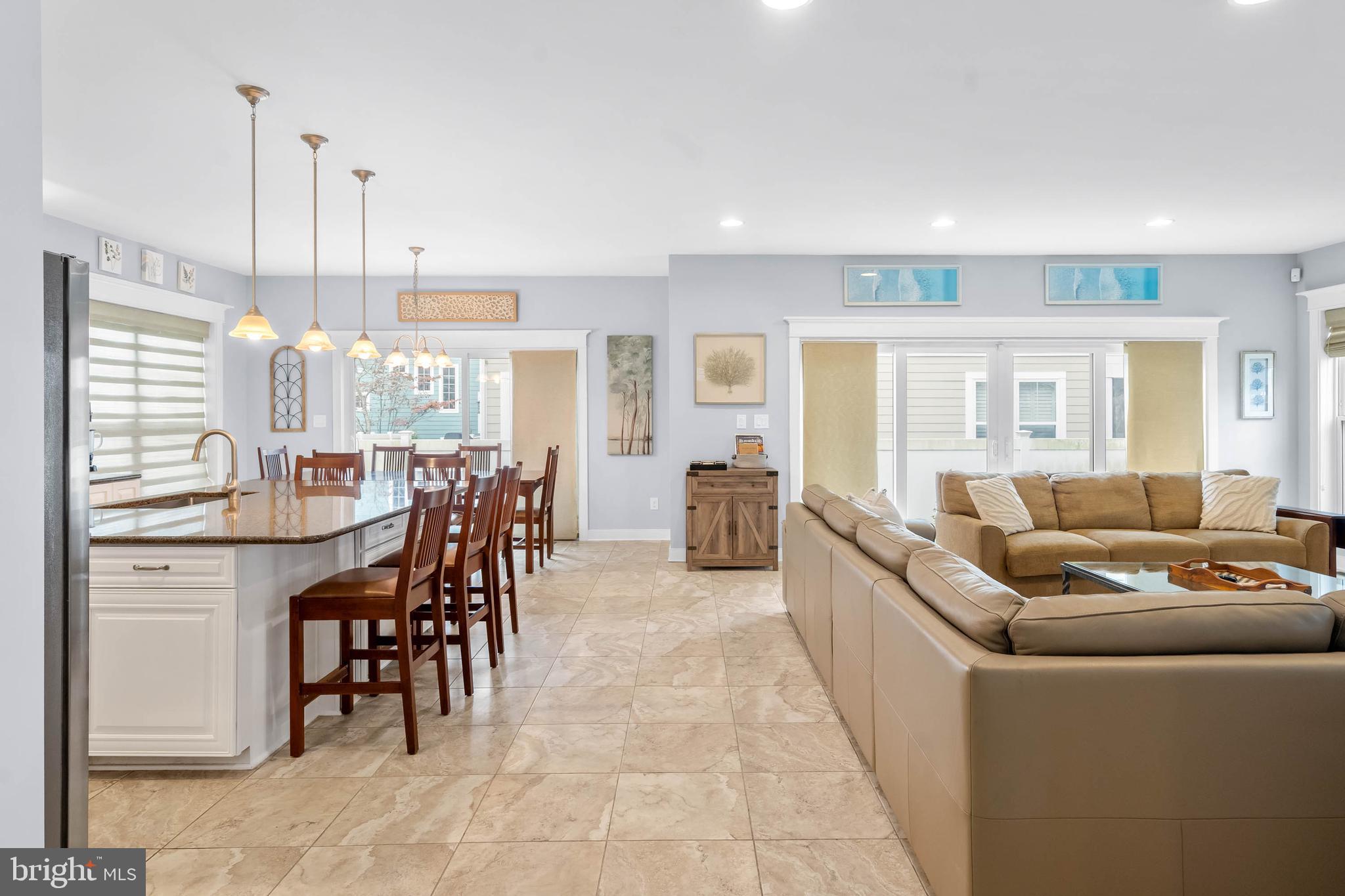507 Jones Lane Rehoboth Beach, DE 19971 - Photo 18 of 62 a living room with furniture a dining table and a wooden floor