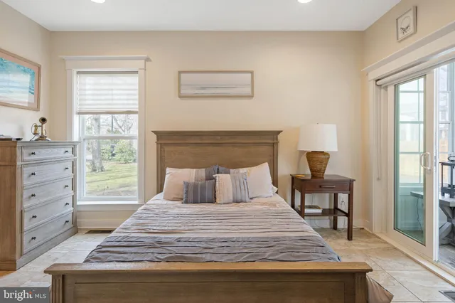 a bedroom with a bed and a flat tv screen