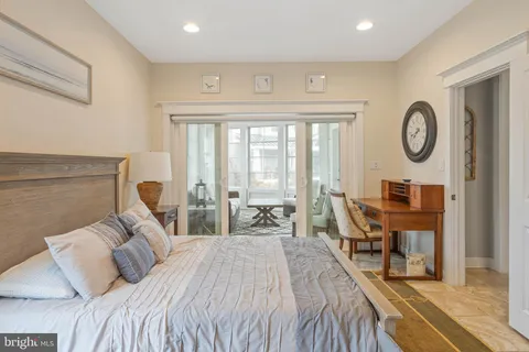 a bathroom with a granite countertop double vanity sink and mirror