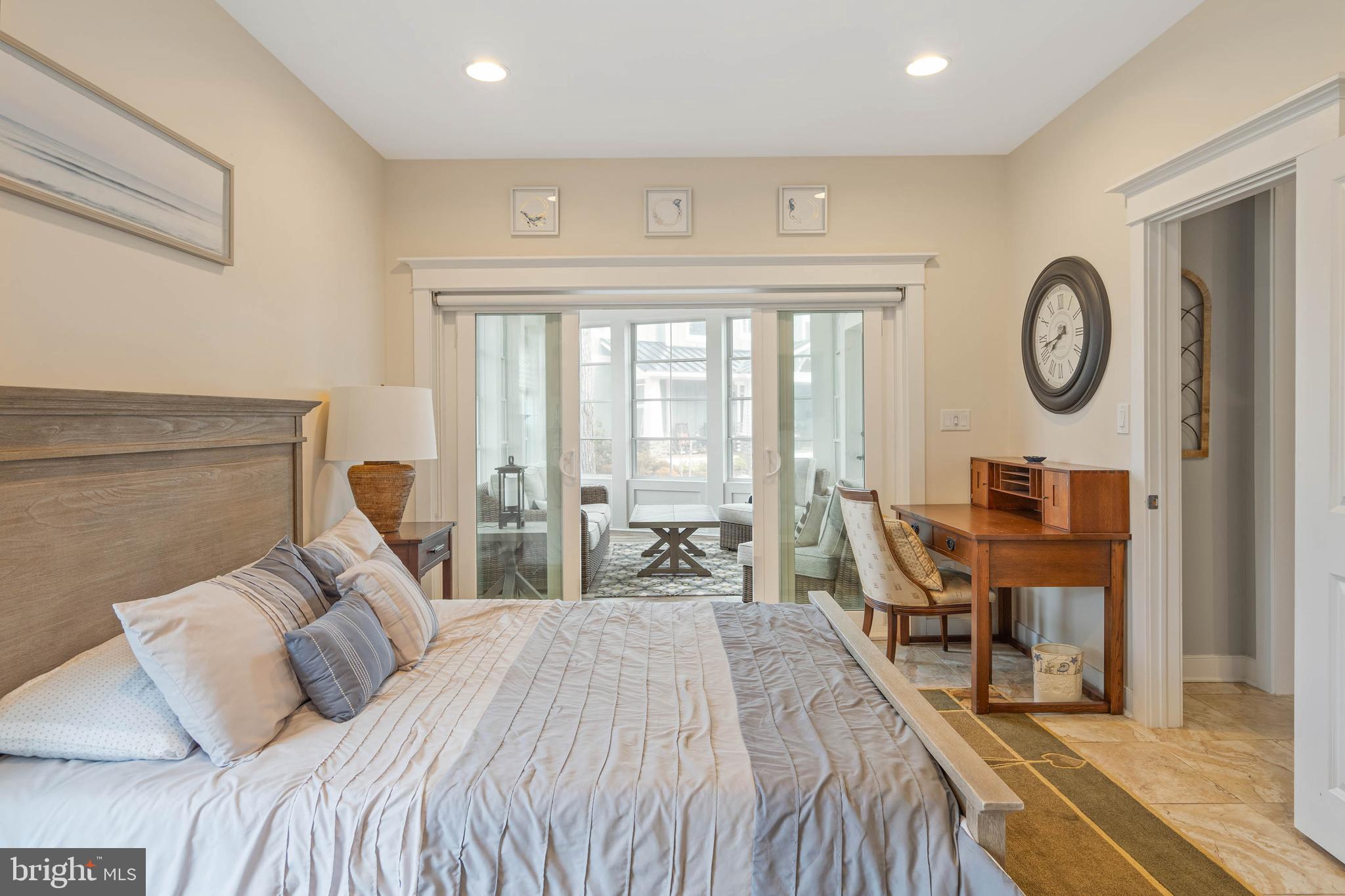 507 Jones Lane Rehoboth Beach, DE 19971 - Photo 22 of 62 a bedroom with a bed a mirror and a large window