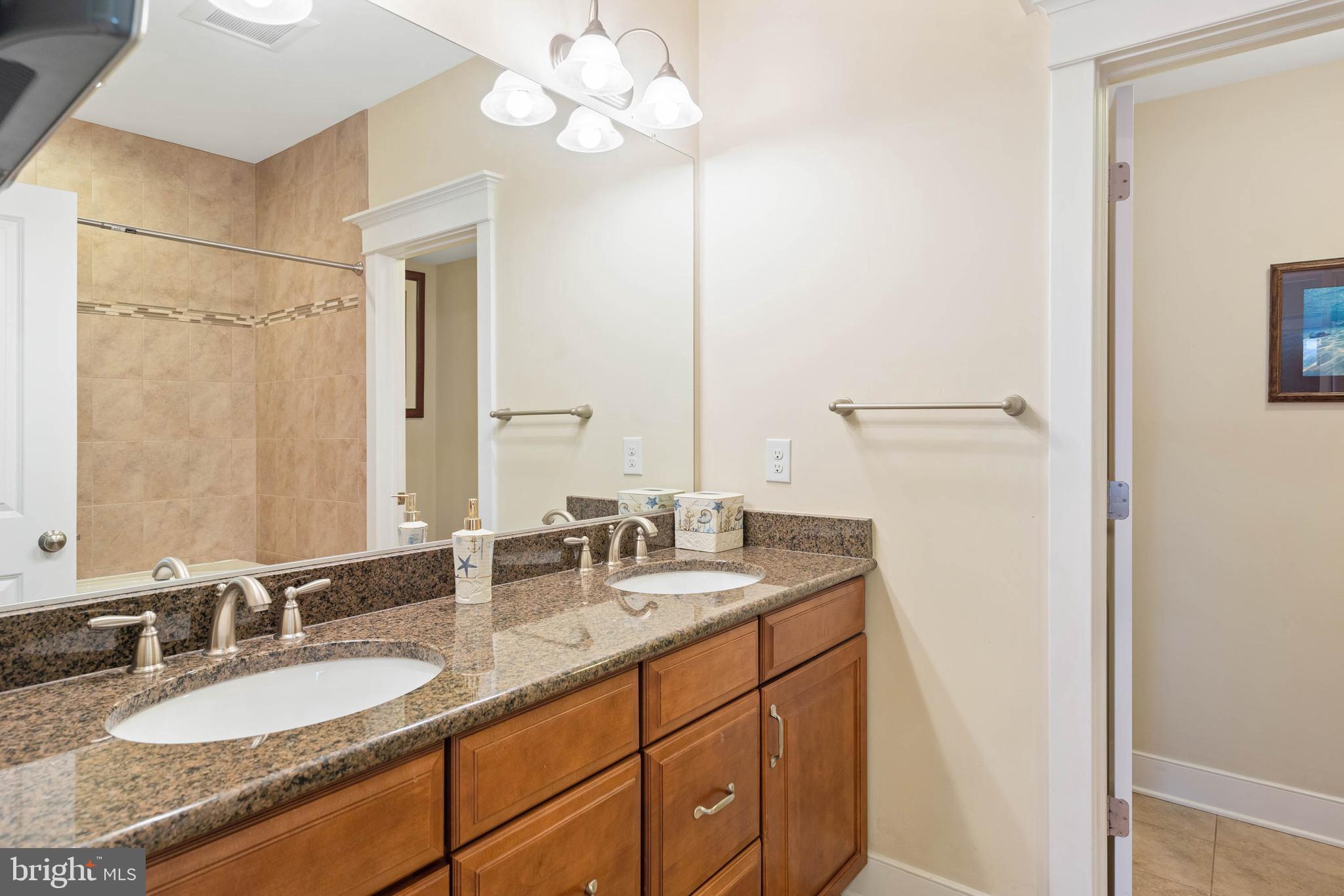 507 Jones Lane Rehoboth Beach, DE 19971 - Photo 23 of 62 a bathroom with a granite countertop double vanity sink and mirror
