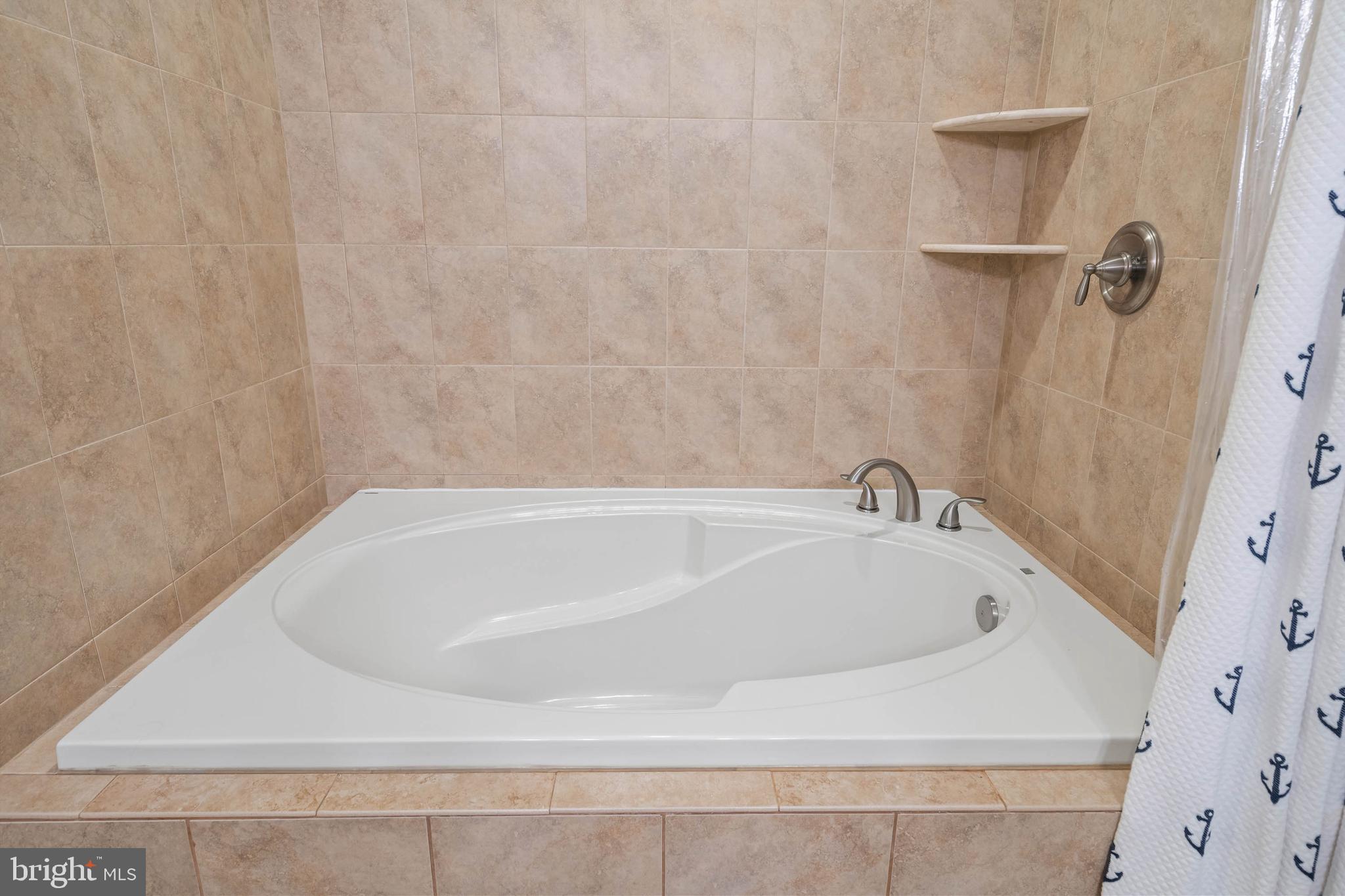 507 Jones Lane Rehoboth Beach, DE 19971 - Photo 24 of 62 a white bath tub sitting in a bathroom