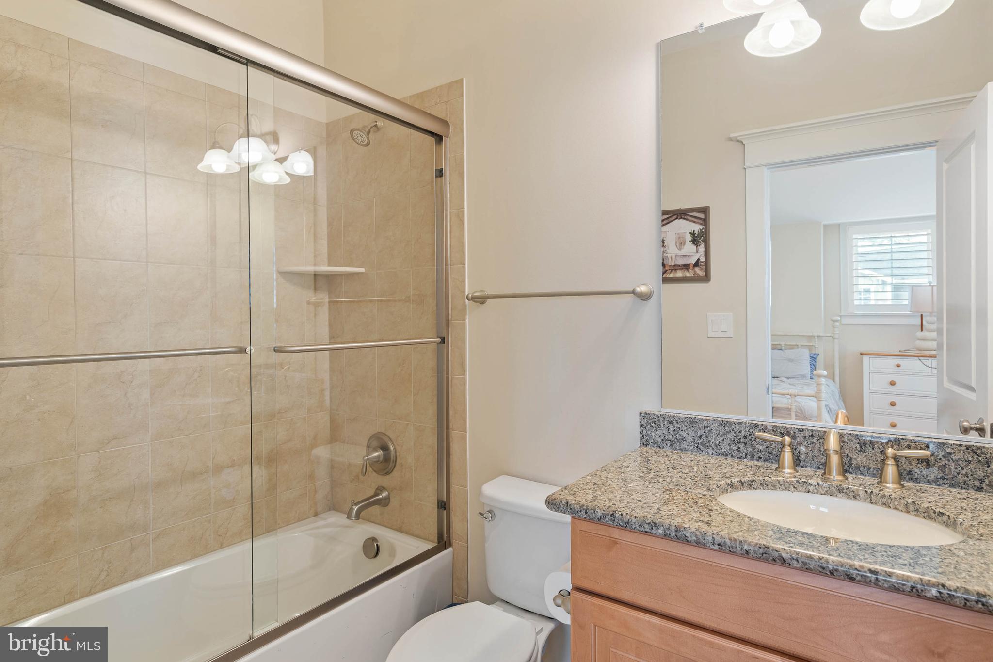 507 Jones Lane Rehoboth Beach, DE 19971 - Photo 36 of 62 a bathroom with a granite countertop sink a toilet and shower