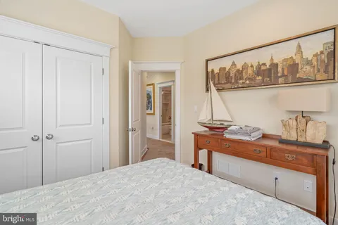 a bed with a white comforter and pillows