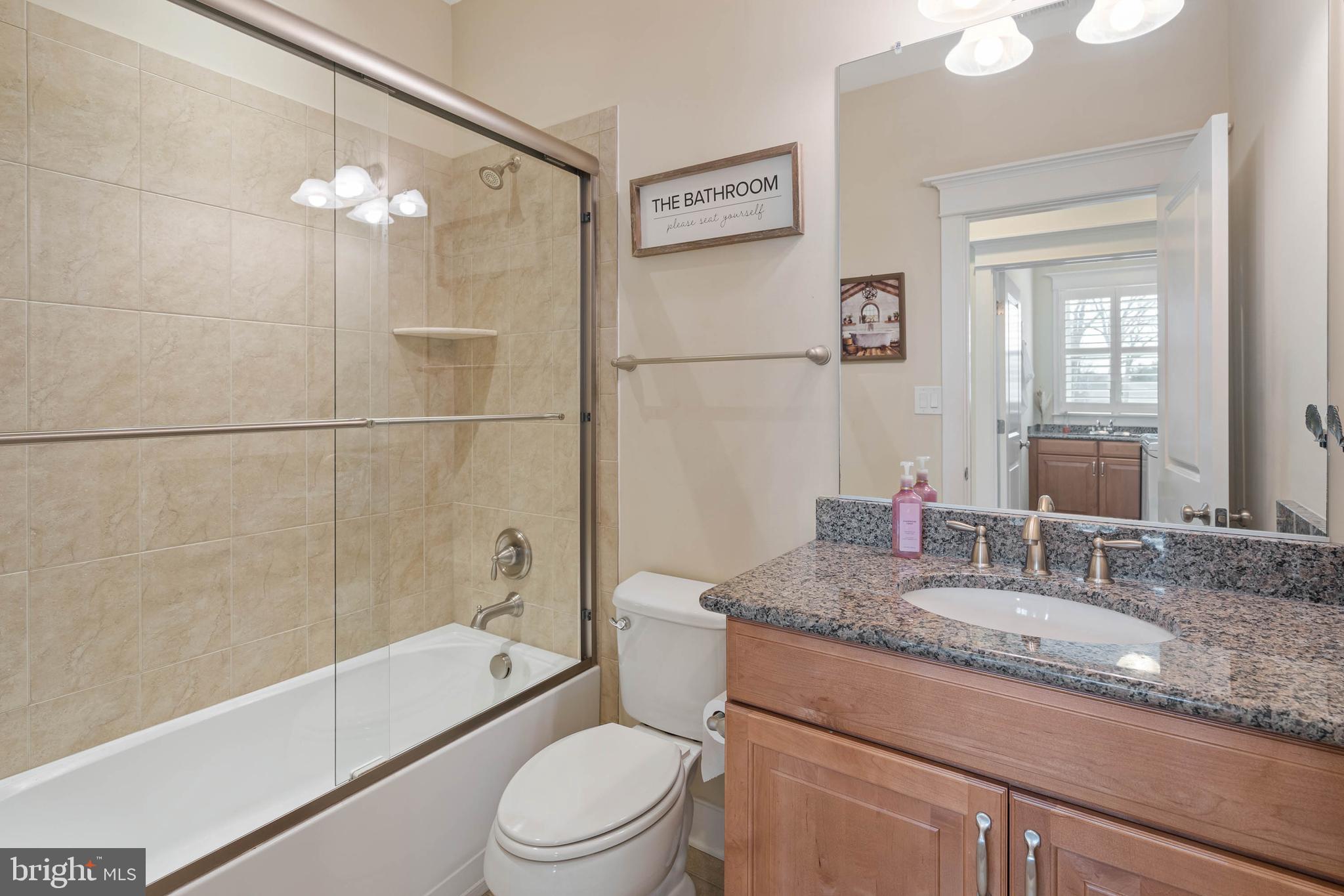 507 Jones Lane Rehoboth Beach, DE 19971 - Photo 44 of 62 a bathroom with a granite countertop sink a toilet and bathtub