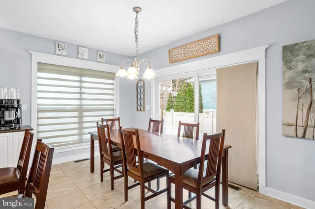 a kitchen with stainless steel appliances granite countertop a sink a kitchen island a stove and a dining table with the kitchen view