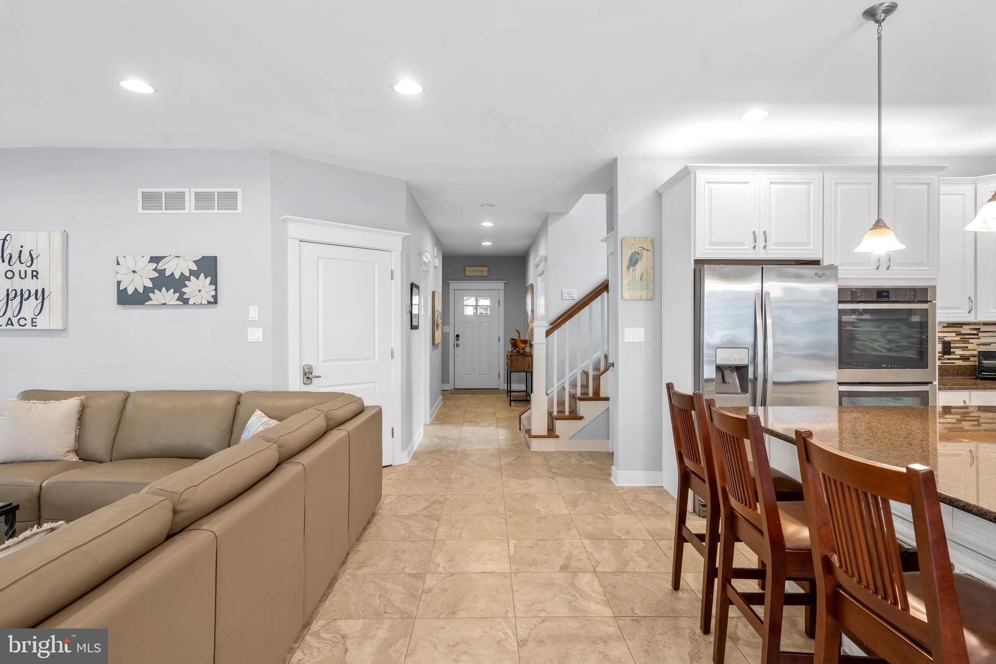 507 Jones Lane Rehoboth Beach, DE 19971 - Photo 9 of 62 a living room with furniture kitchen and a chandelier